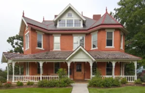 Campbell Asset Management's office: a red brick Victorian house with a white wraparound porch and red trim.